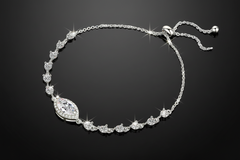 Silver bracelet with a central pendant on a light grey background