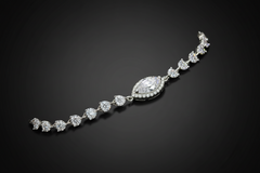 Silver bracelet with clear stones on a light grey background