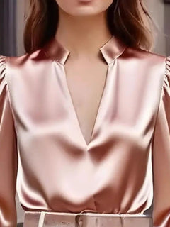 Pink notched long-sleeve blouse with deep V neckline and satin-like sheen