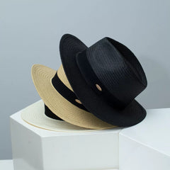 Straw wide brim hats with ribbon, black and beige, on display