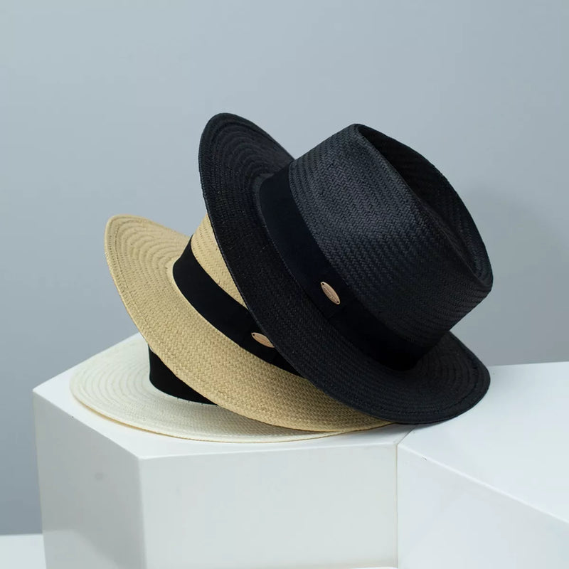 Straw wide brim hats with ribbon, black and beige, on display