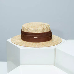 Straw boater hat with brown ribbon band and beige woven brim