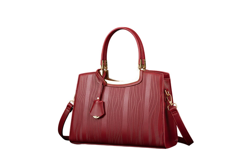 Red leather top-handle handbag with gold trim, front tassel, and crossbody strap