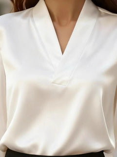 White V-neck long sleeve satin blouse close-up of V-neckline and front panel