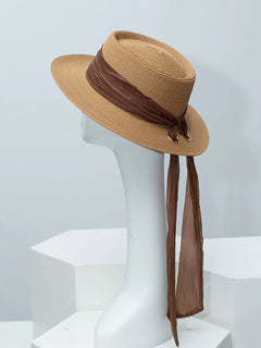Ribbon-accent straw sun hat in brown with draped brown ribbon ties