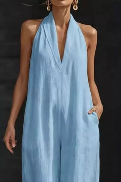 Light blue sleeveless wide-leg halter jumpsuit with deep V neckline and loose drape