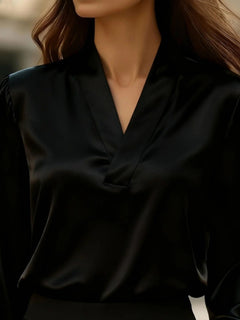 Black V-neck long sleeve satin blouse close-up of collar and front seam