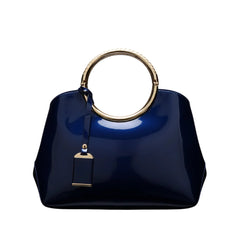 Glossy indigo handbag with round gold ring handle and dangling key charm