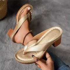 Gold-tone toe-post block-heel sandals with perforated footbed and crisscross thong straps.