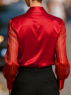 Back view of red collared blouse with sheer striped sleeves