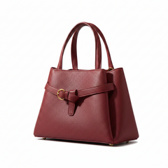 Burgundy leather top-handle handbag with textured finish and gold buckle strap