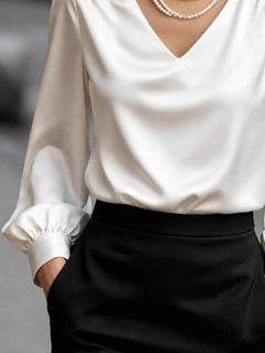 White satin V-neck blouse with puff sleeves and gathered cuffs