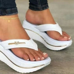 White platform toe-post sandals, thick sole with gold logo bar on the front strap.