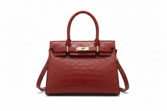 Burgundy crocodile-embossed leather top handle handbag with gold clasp