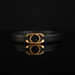 Black leather statement buckle belt with gold-tone ring and bar buckle plate
