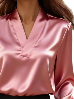 Pink V-neck long sleeve satin blouse close-up of V-neckline and smooth fabric